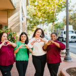team members showing heart at the camera