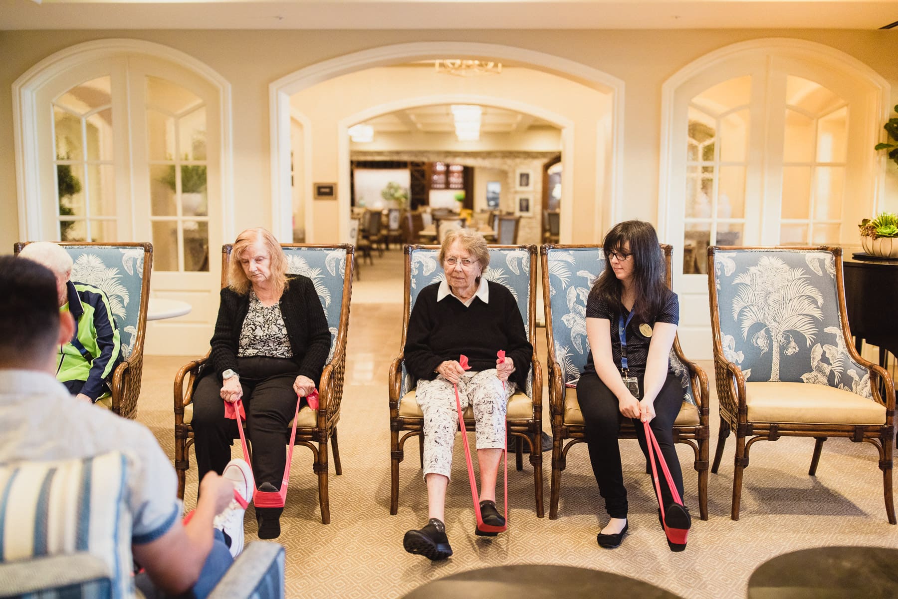 adults and elderly engaging in chair exercises