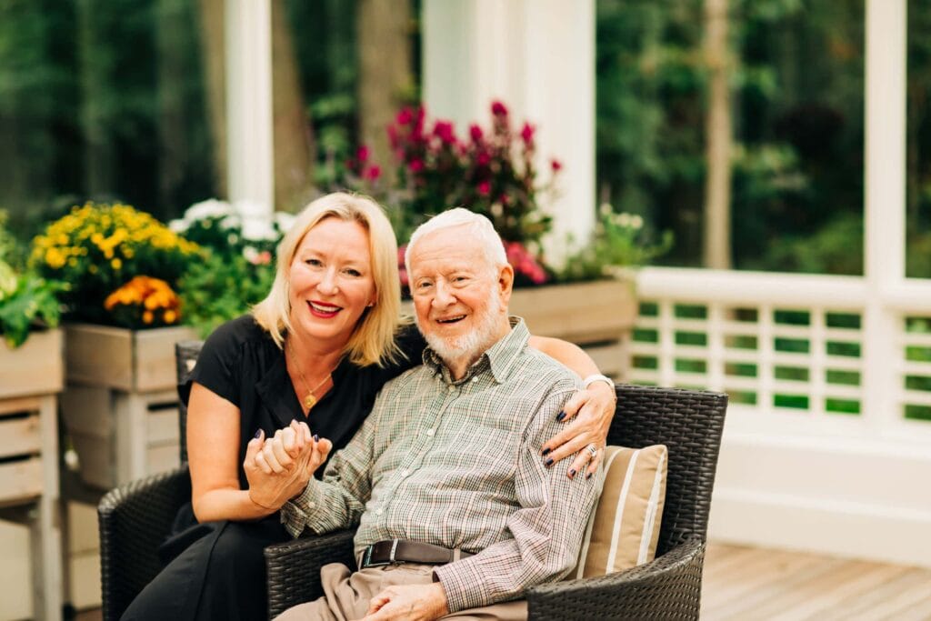 daughter and senior father smiling outdoors