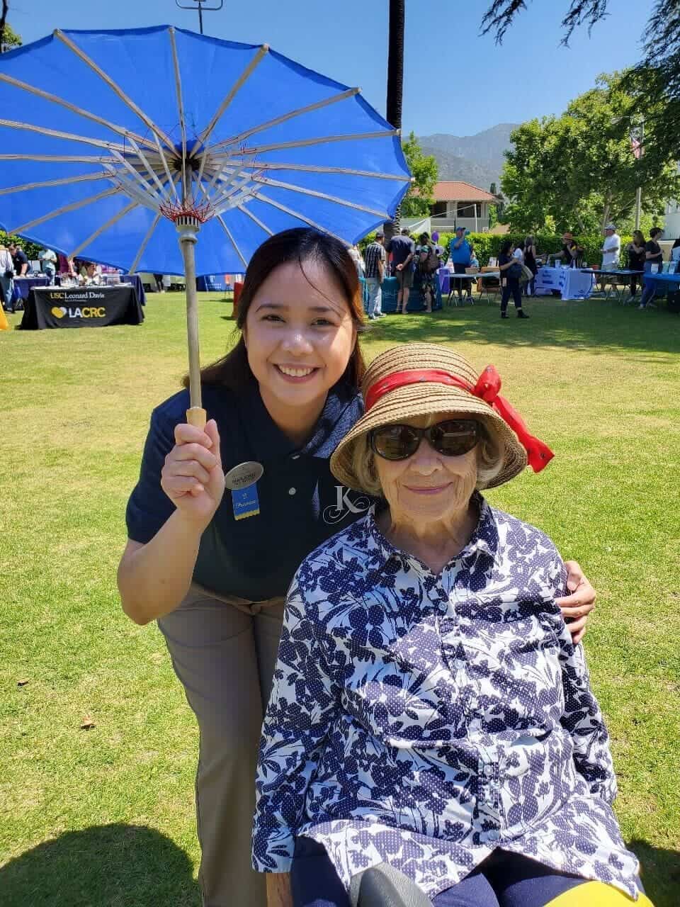 resident and team member outside at a community event