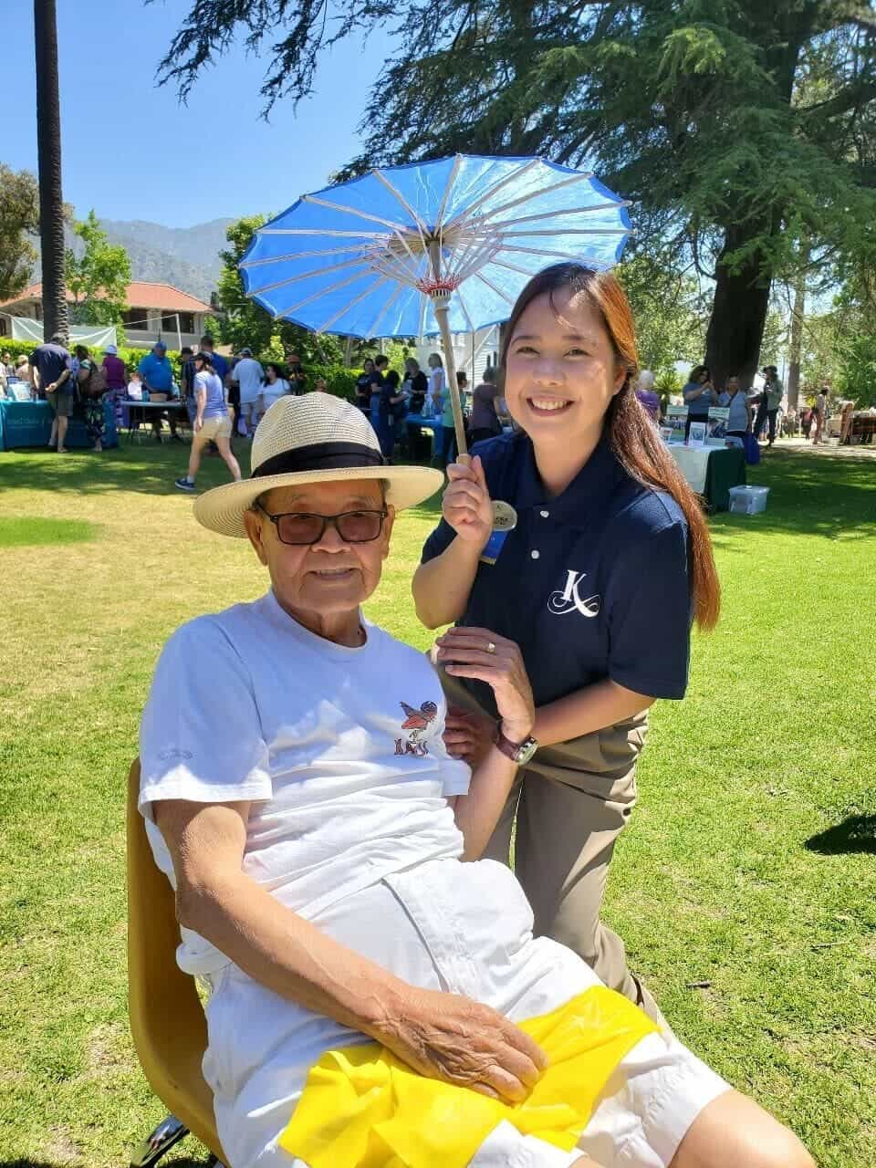 resident and team member outside at a community event