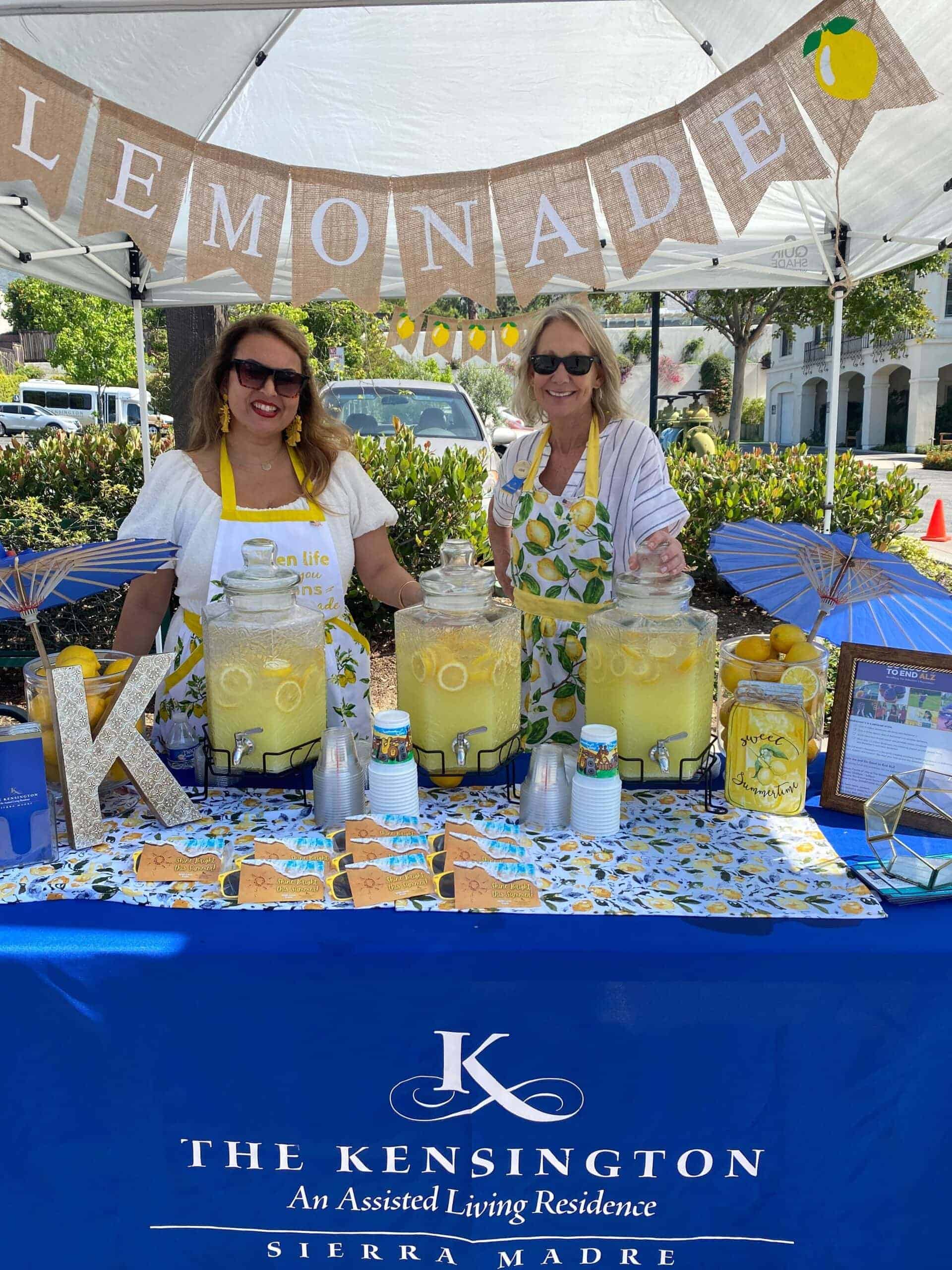 team members running lemonade stand at community event