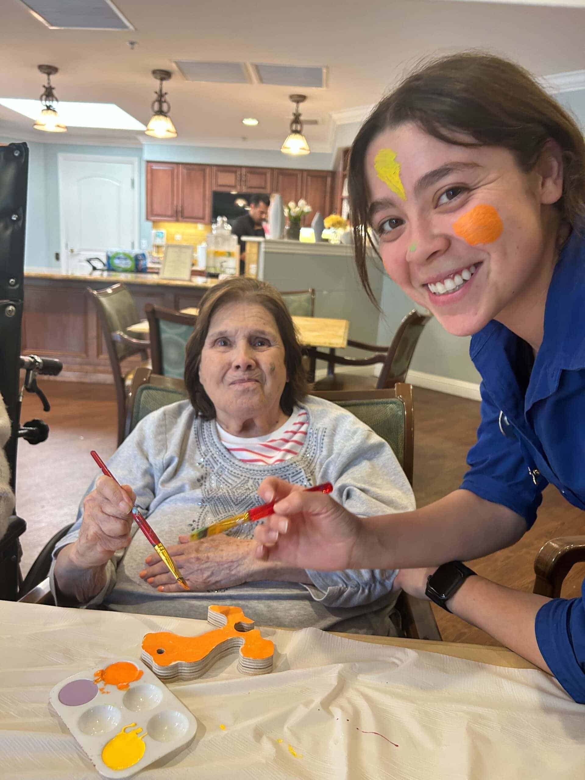 resident and team member during painting activity