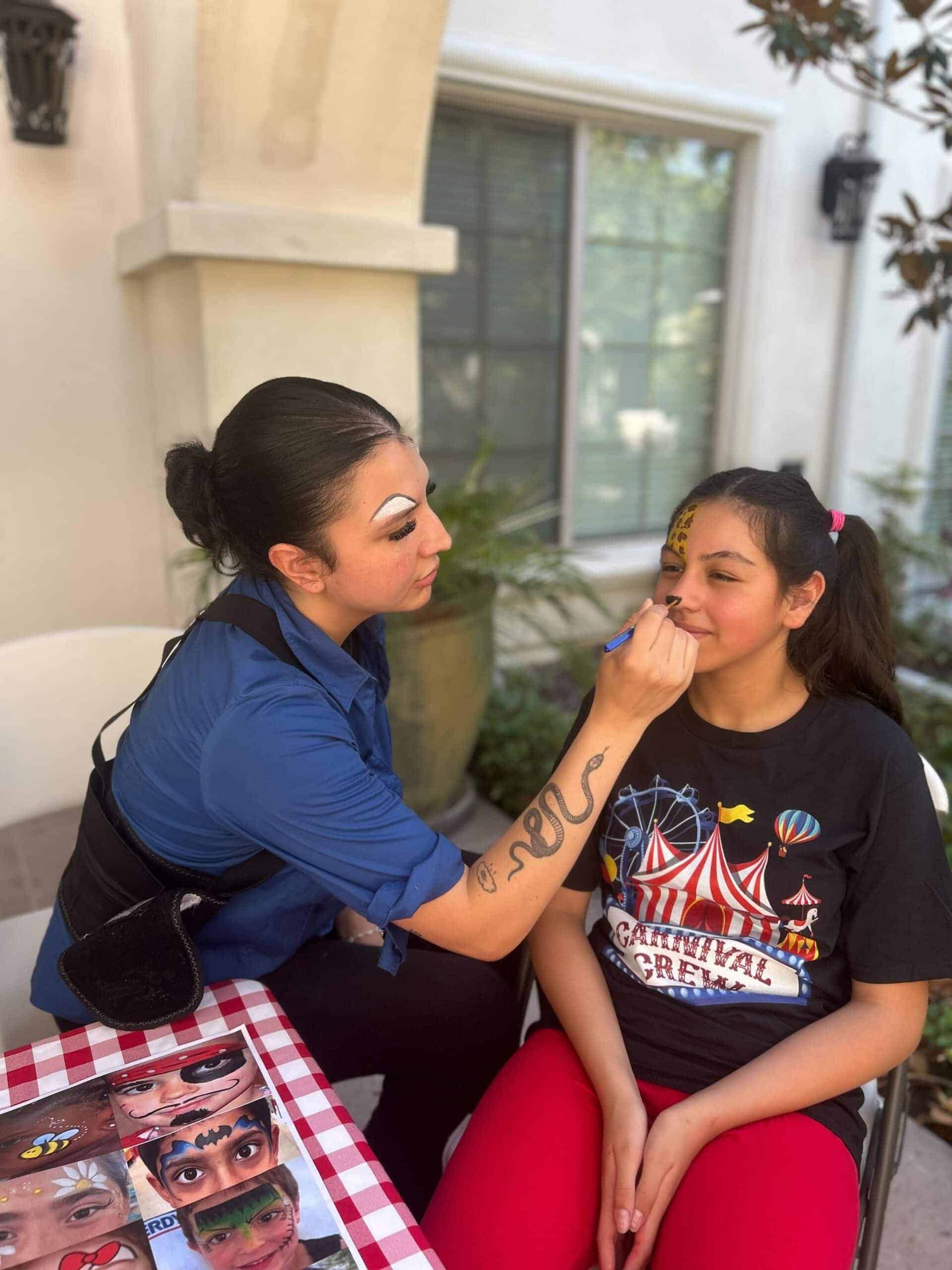 team members getting face painted