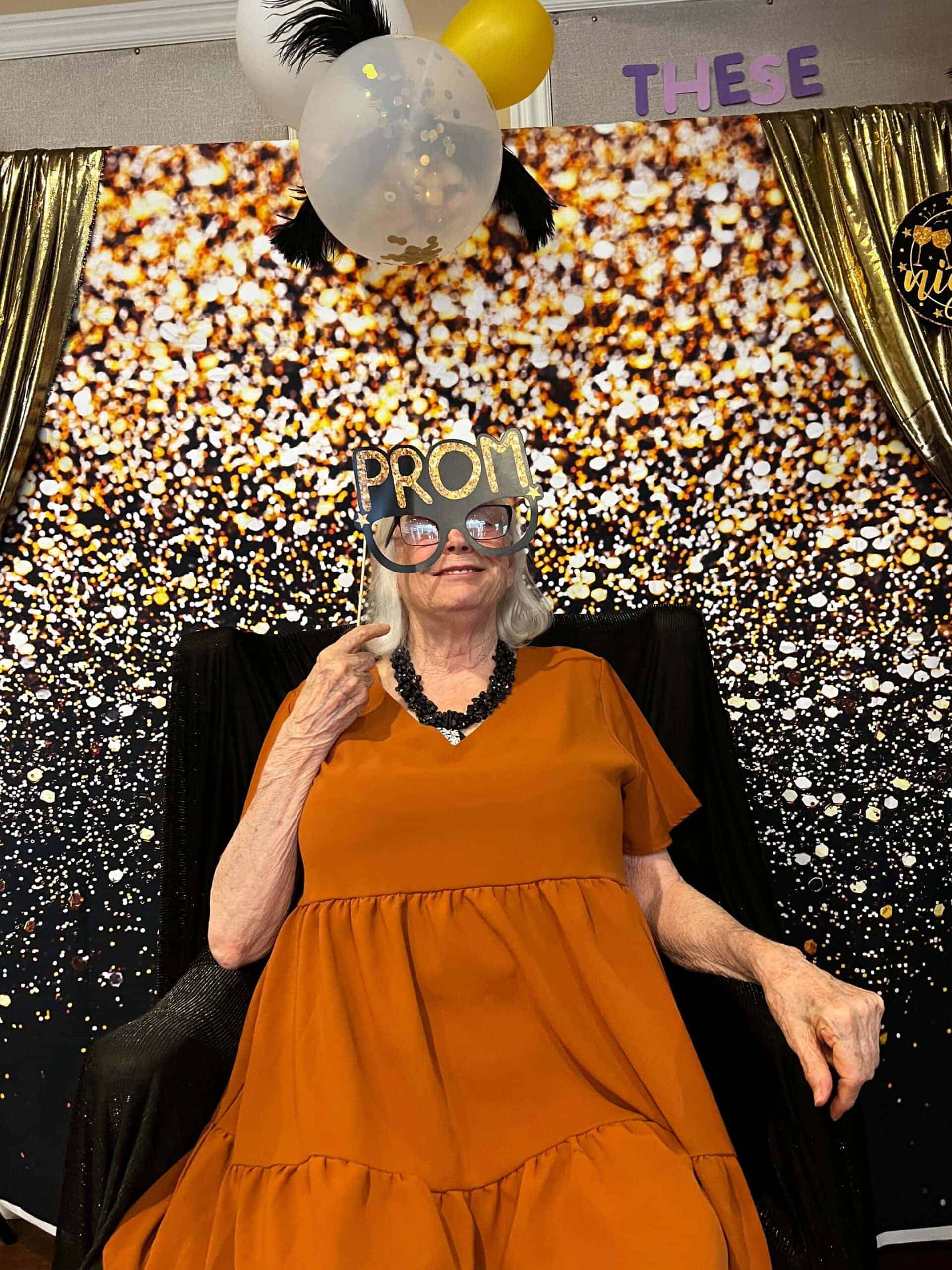 resident posing for photo during prom event