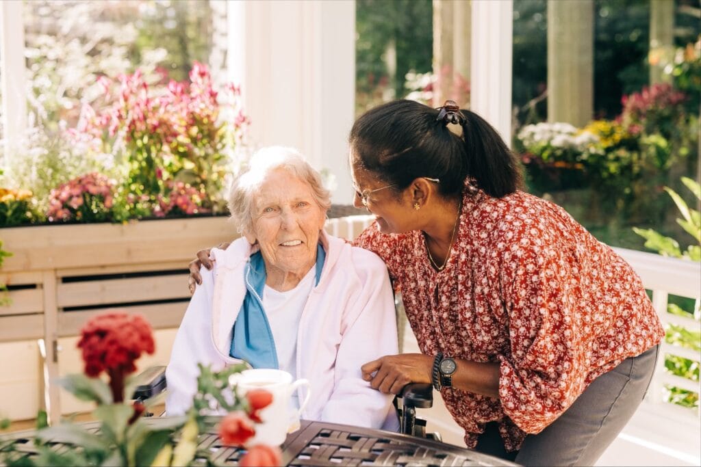 two women smiling at one another