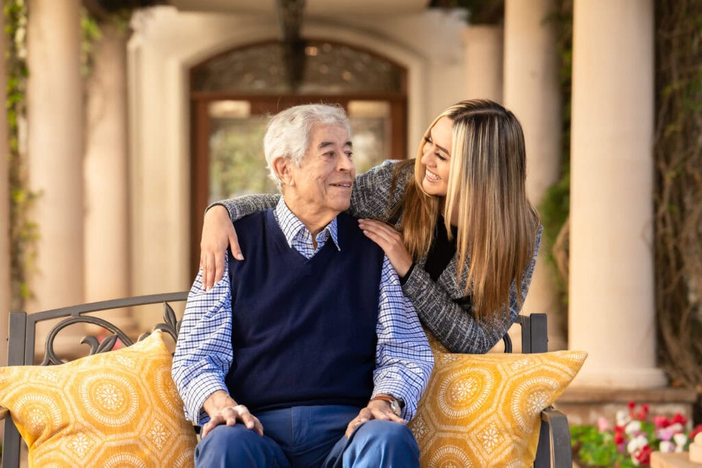 woman smiling at older man sitting down